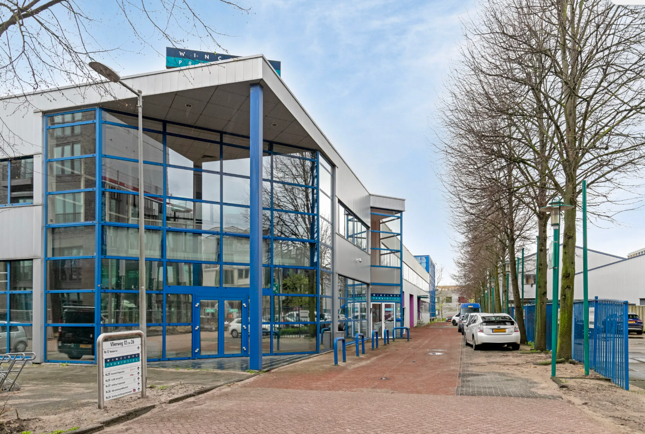 ExcaliburHQ studio at Vlierweg 12, Amsterdam, modern building with blue glass façade